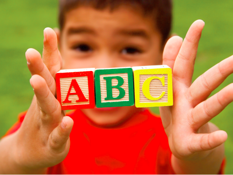 <p>child with ABC letter blocks</p>